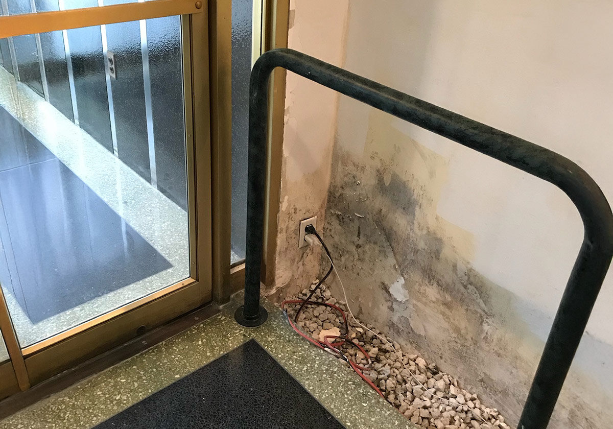 A Metal Railing Positioned Adjacent To A Door, Providing Support And Safety In The Entryway.