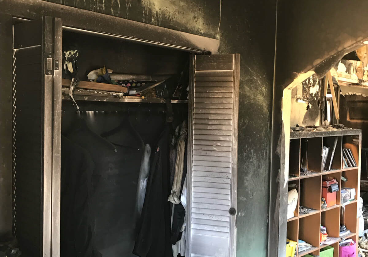 A Room With Burnt Closet And Clothes